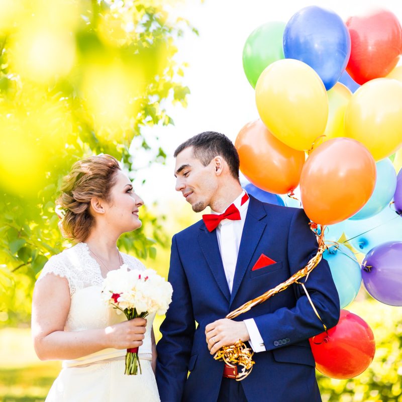 Happy bride and groom with balloons